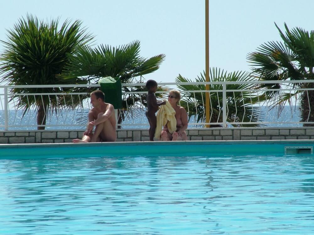 Photo of naturists in an outdoor pool - Visiting the Beach Without Clothes